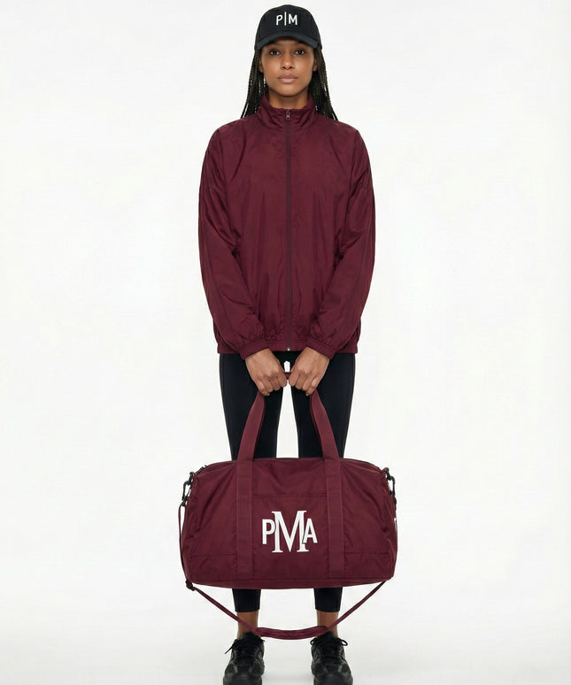THE PMA ESSENTIAL BURGUNDY DUFFEL BAG