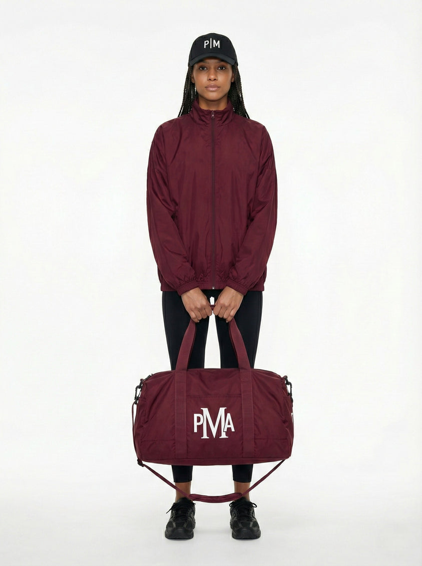 THE PMA ESSENTIAL BURGUNDY DUFFEL BAG